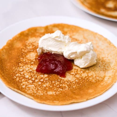 oat pancake with strawberry jam and whipped cream