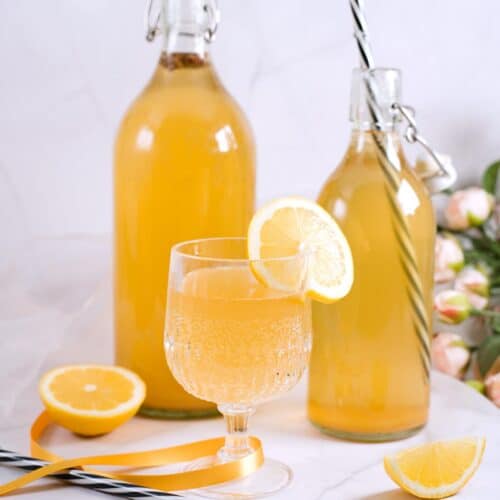 sima lemonade in glass and bottles.