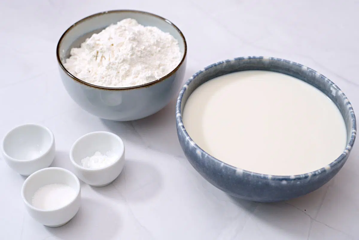 Plant milk, flour, sugar, salt and baking powder in small bowls. 