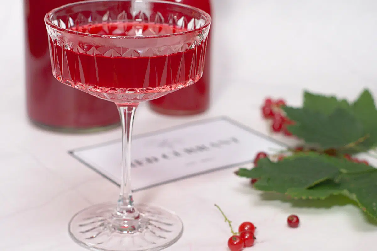 A champagne glass with red juice. 