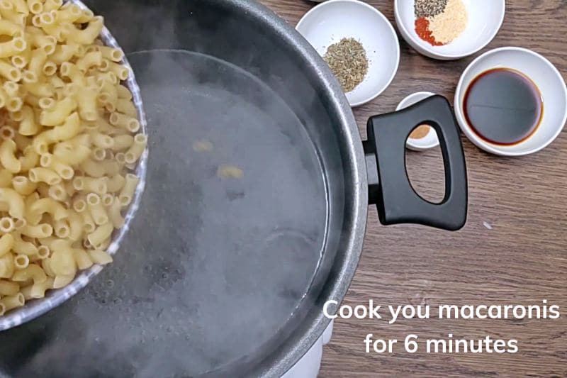pouring macaroni into boiling water. 