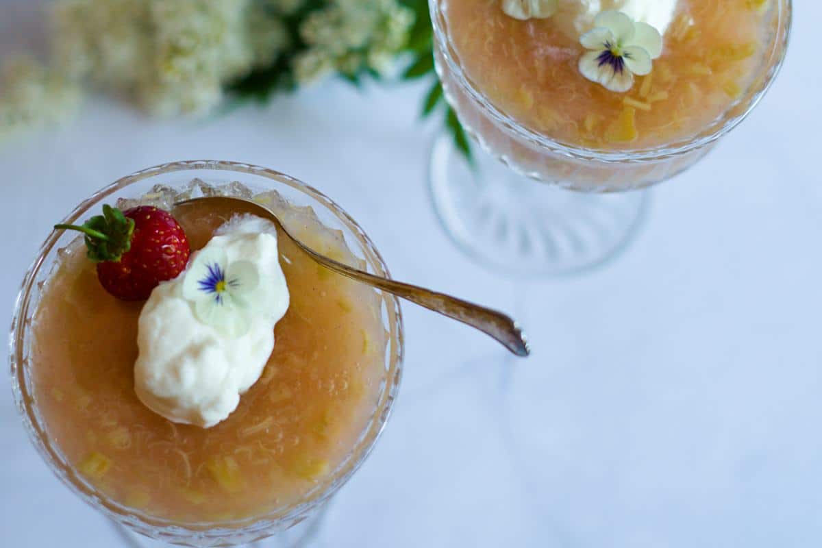 rhubarb soup bowls decorated with whipped cream and strawberry. 