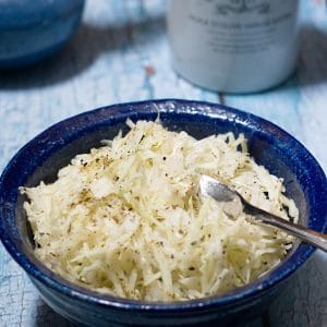 shredded cabbage salad in blue bowl.