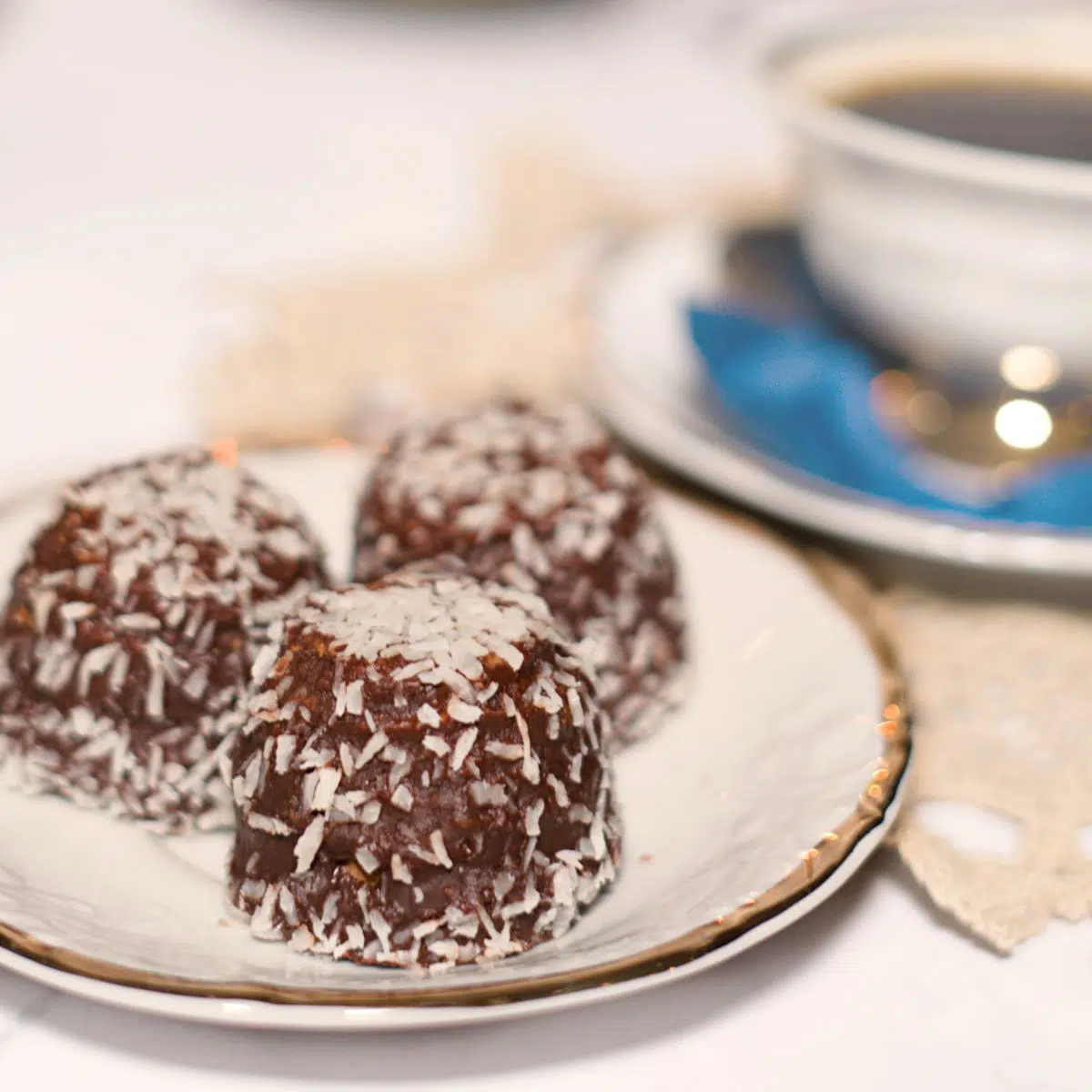 3 chocolate balls on platter with coffee.