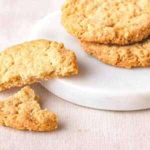 thin oat cookies on white plate.