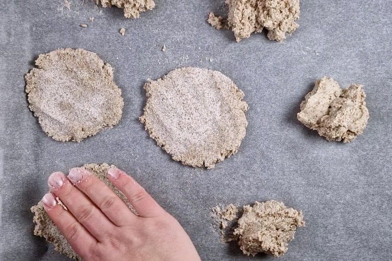 flattening of dough balls with hand. 
