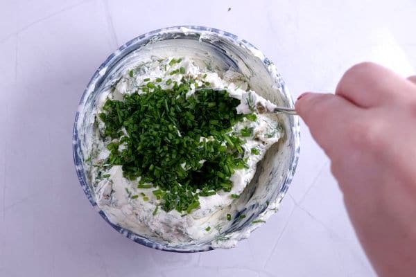 cream cheese in bown with spices and herbs. 