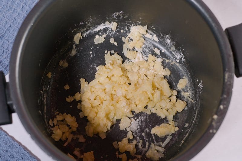 onion and flour mix in black pan. 