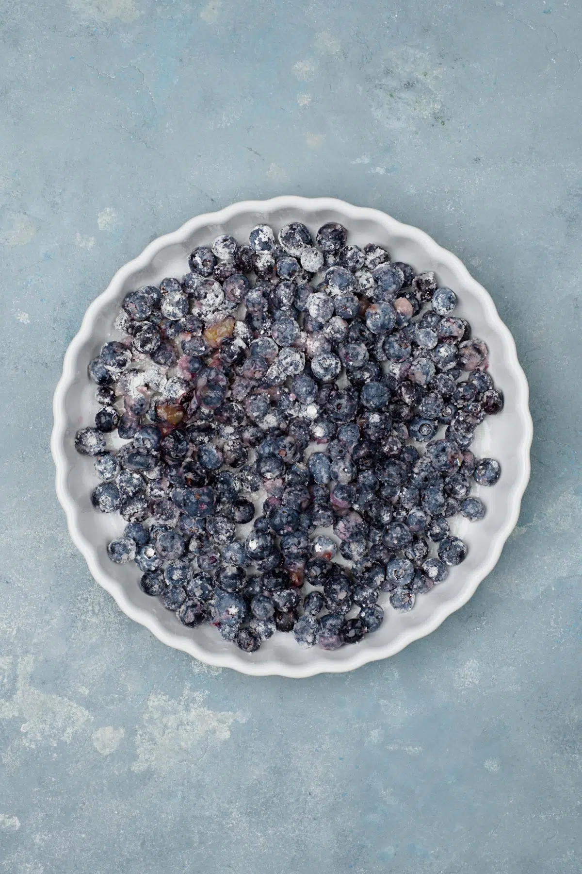 Blueberries rolled in starch on the bottom of the pan. 