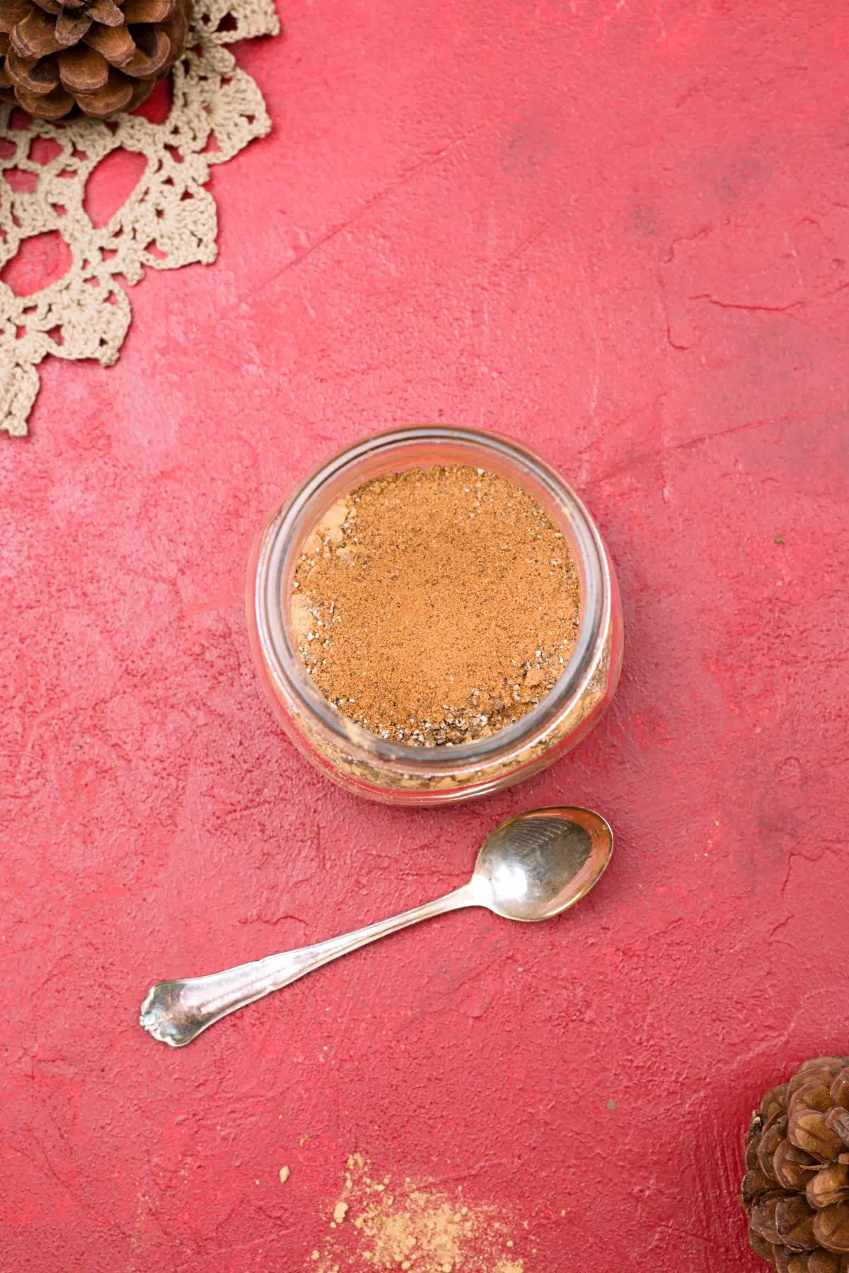 spices in jar with spoon, unmixed.