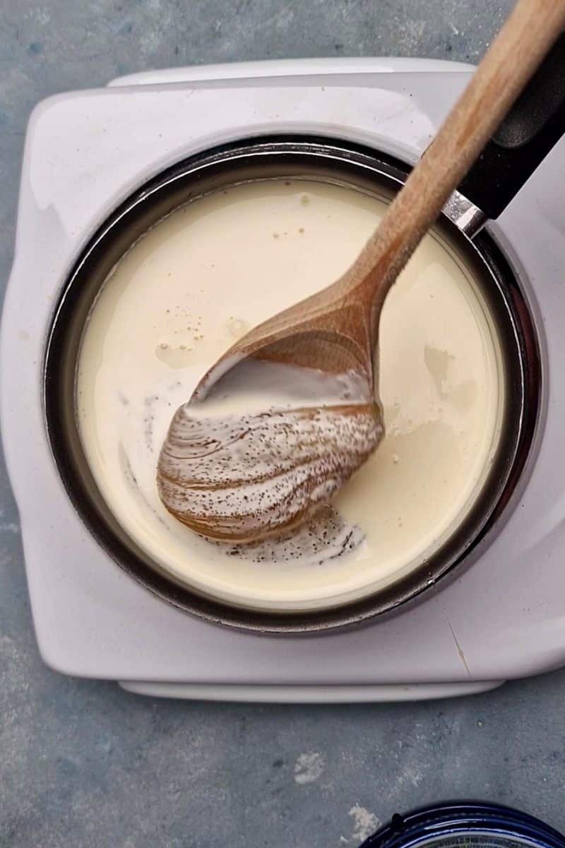 cream, sugar and syrup in the mixing with a wooden spoon on stovetop. 