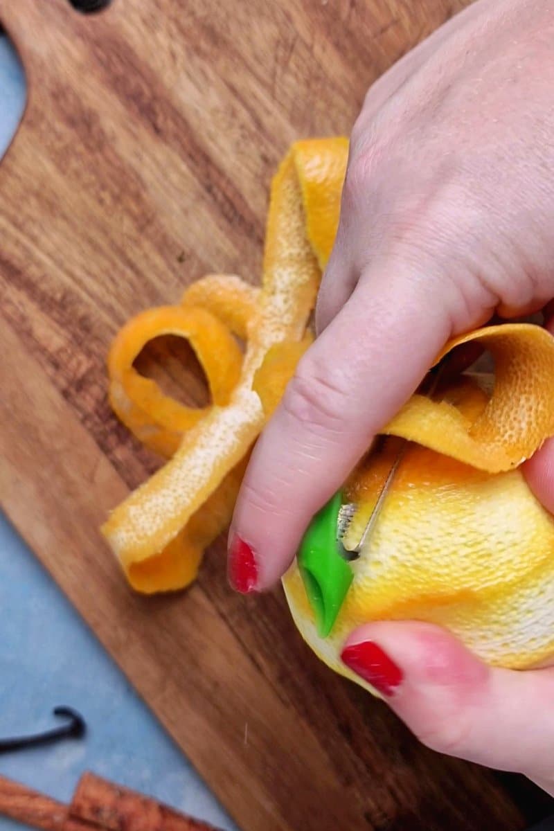 hand peeling an orange