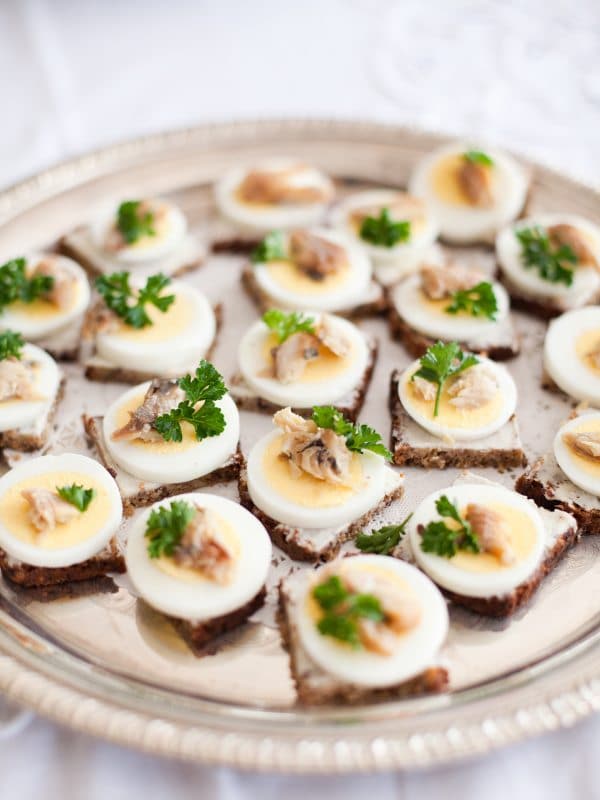 small appetizer bites on plate from rye bread. 