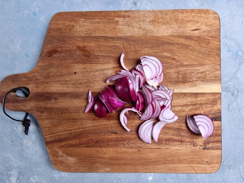 sliced red onion on cutting board. 