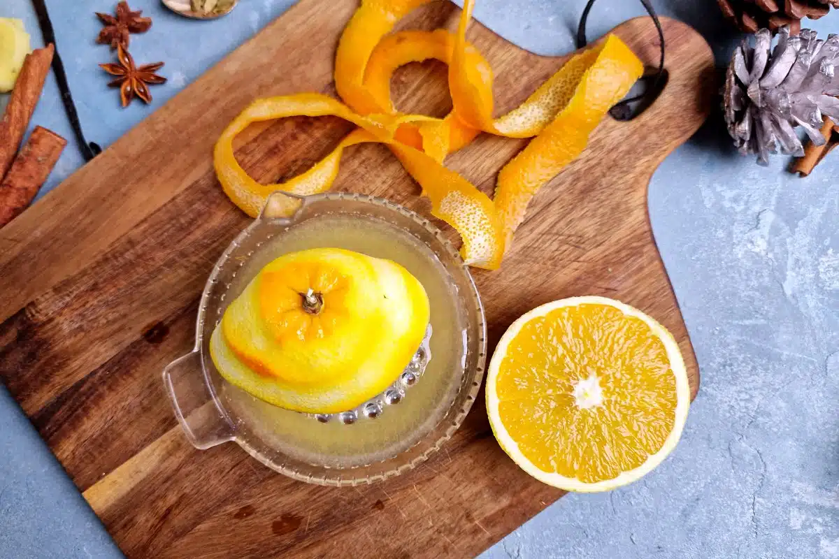 orange peel and orange being juiced. 