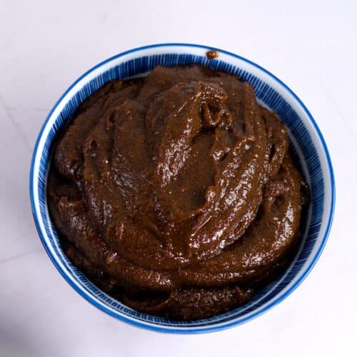 A blue bowl with Finnish mämmi-brown rye pudding.