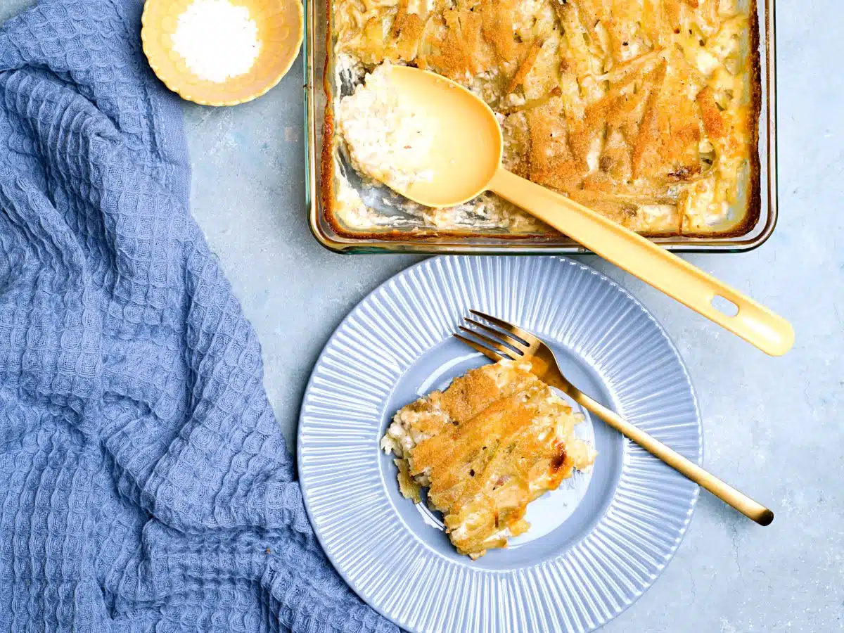 casserole on blue plate and in oven form with a yellow ladle.