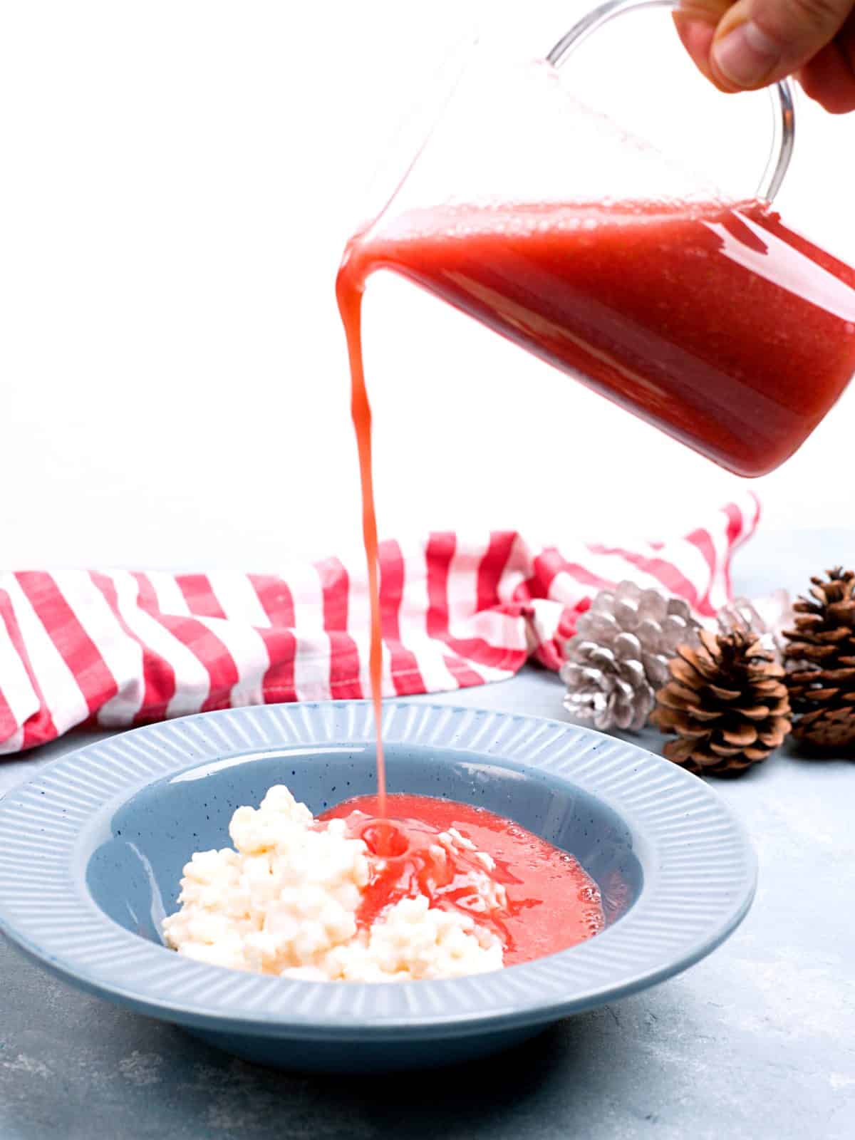 pouring shot of strawberry sauce on porridge.