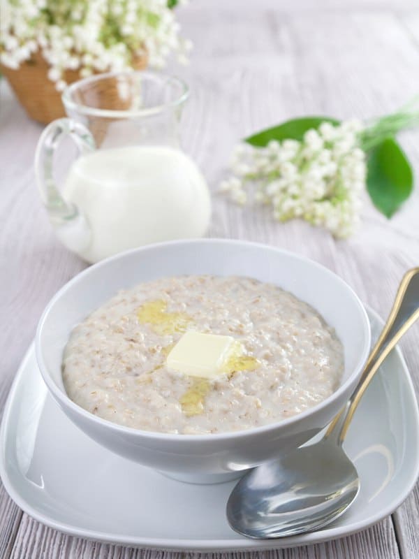 oat porridge on plate with butter. 