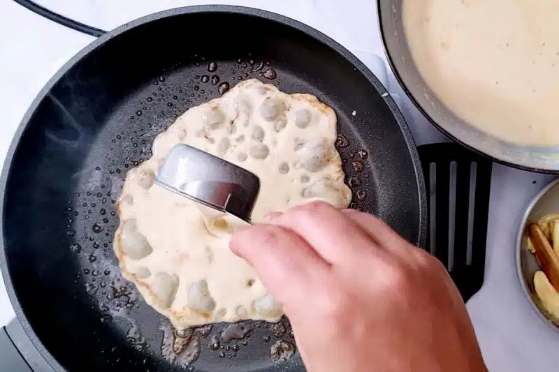pouring batter on pan. 