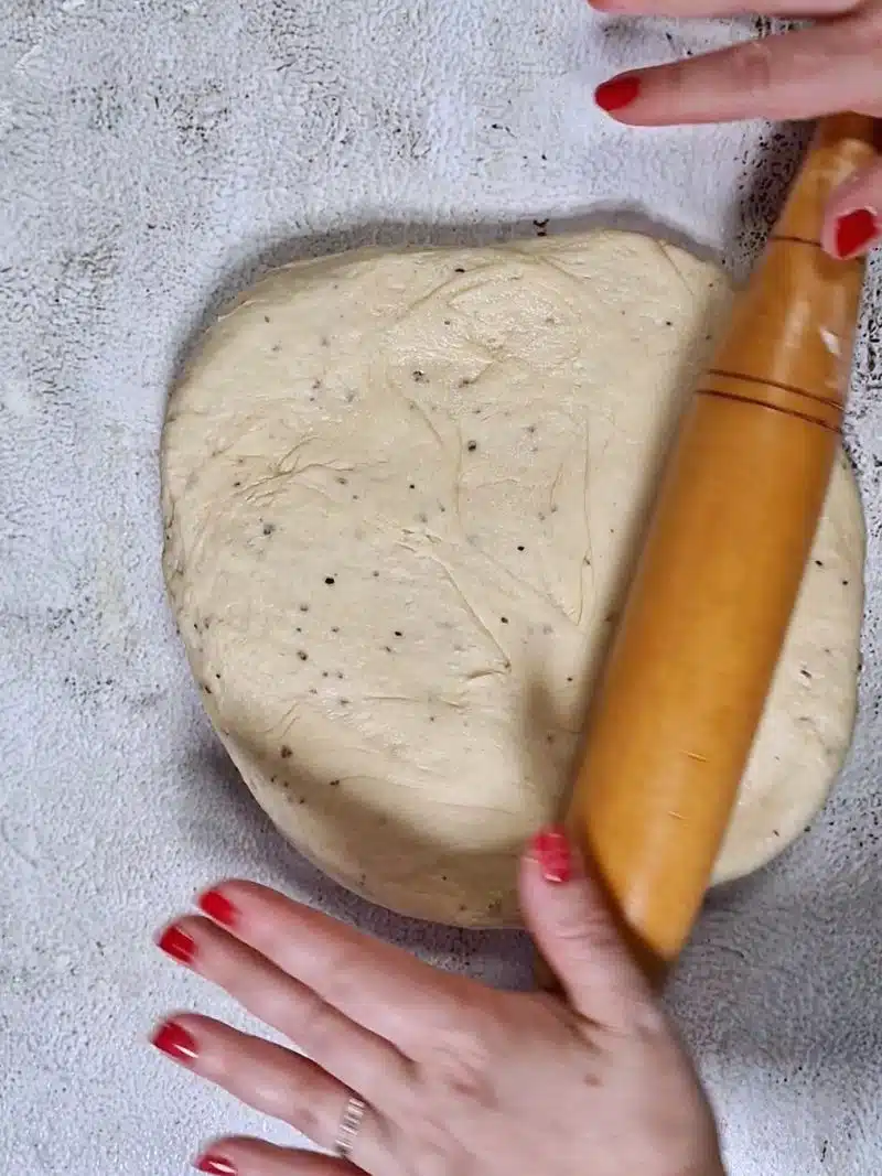 rolling out dough with rolling pin. 
