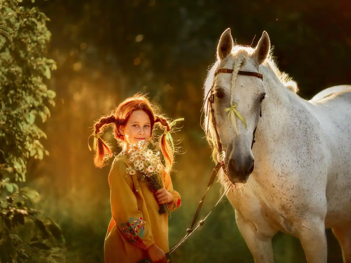 Pippi character from Astrid Lindgren story with a white horse. 