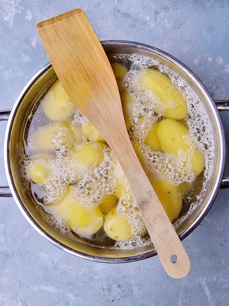 Potatoes boiling in large pot. 