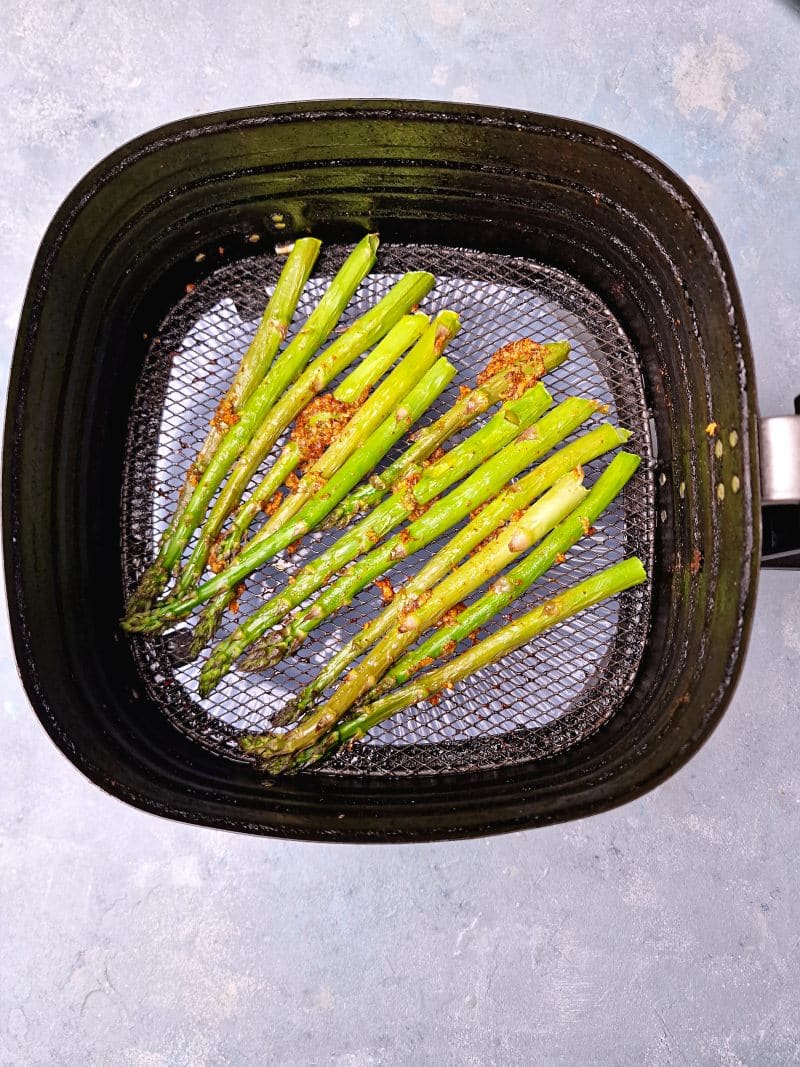 Baked asparagus in large air fryer basket. 