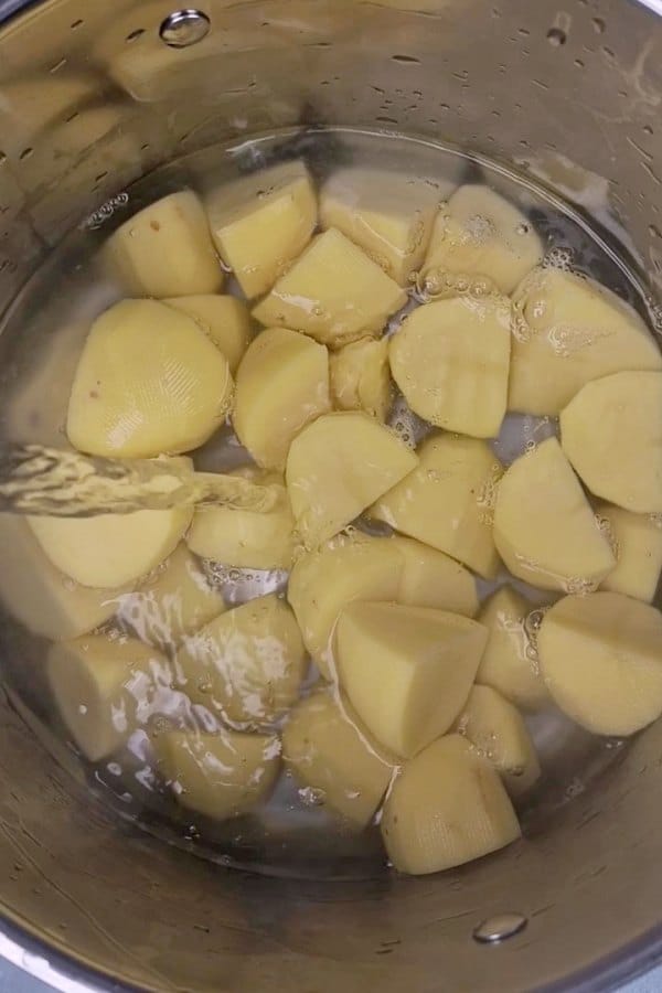 potatoes covered with water in pot. 