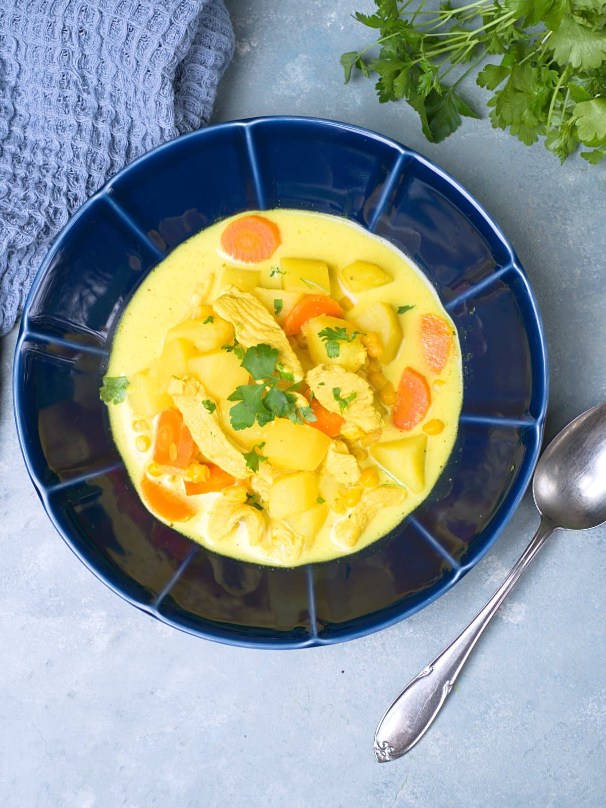 yellow chicken curry soup decorated with fresh cilantro. 