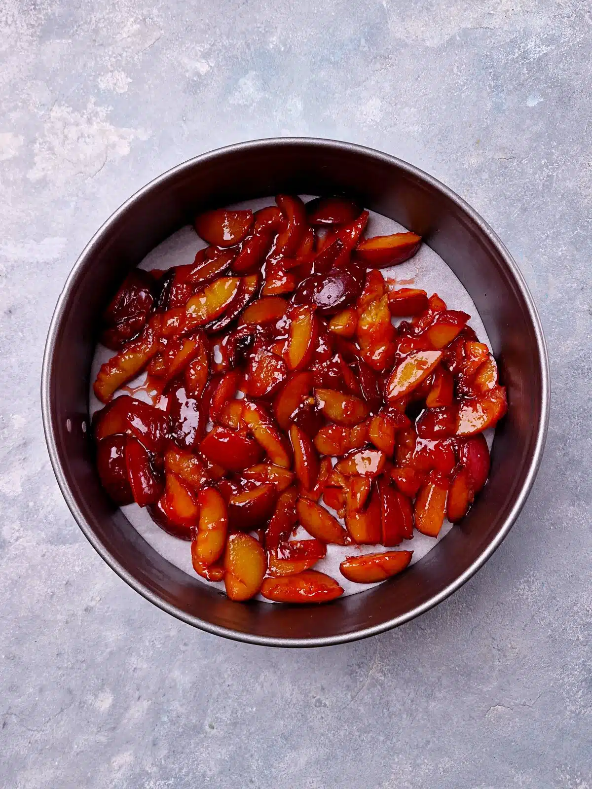Caramelized plum bites in springform pan. 