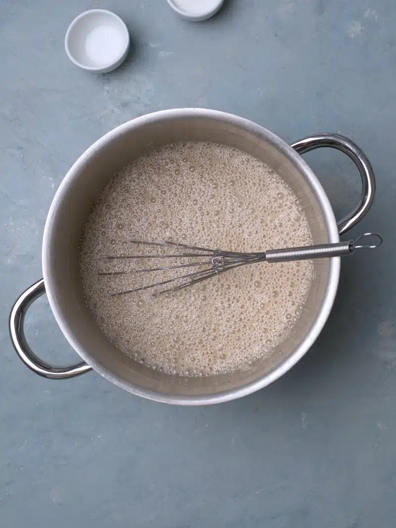 Whisked water and flour in metallic pan.